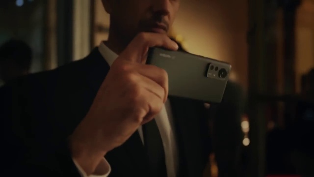 Video Reference: Flash photography, Gesture, Audio equipment, Communication Device, Blazer, Gadget, Photographer, Formal wear, Mobile phone, Wrist