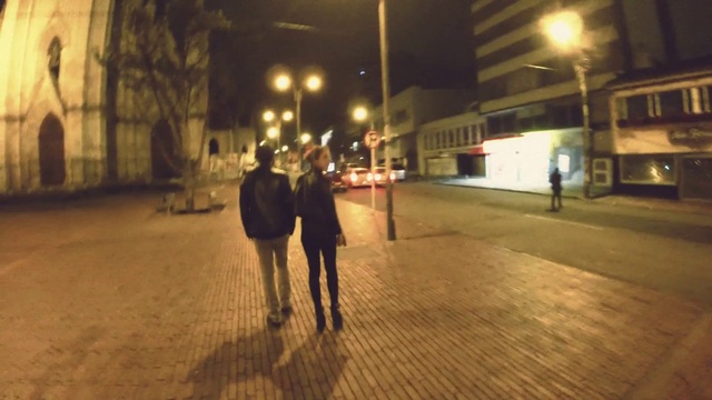Video Reference: Road surface, Street light, Building, Standing, Architecture, Sidewalk, Thoroughfare, Road, Automotive lighting, Asphalt
