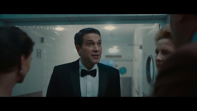 Video Reference: Forehead, Chin, Eyebrow, Jaw, Flash photography, Coat, Gesture, Suit, Blazer, Formal wear