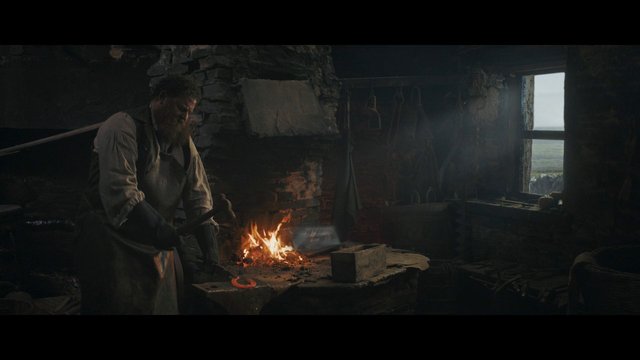 Video Reference: blacksmith, forge, fire, rustic interior, bearded man, tools, workshop, metalworking, historic, dim light, cabin, manual labor, smoke, interior, window, craft