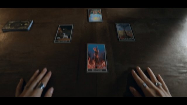 Video Reference: tarot, cards, divination, reading, fortune, wooden table, hands, rings, mystical, spiritual, occult, top view, spread, indoor, close-up