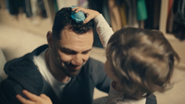 Video Reference: child, adult, toy, playful, indoor, family, interaction, smiling, close-up, home, parenting, toddler, bonding