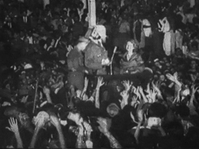 Video Reference: Crowd, Monochrome, Event, Monochrome photography, Hat, Art, Crew, Font, History, Audience