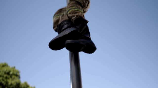 Video Reference: boots, feet, pole, low angle, outdoor, sky, balance, acrobatics, climbing, metal, action, closeup, motion, tree