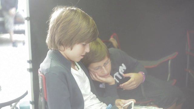 Video Reference: Chair, Event, Fun, T-shirt, Child, Science, Recreation, Bangs, Sitting, Tableware