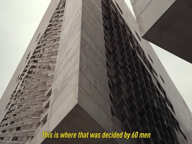 Video Reference: Building, Sky, Rectangle, Tower block, Grey, Commercial building, Composite material, Facade, City, Symmetry