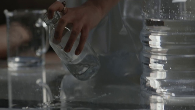 Video Reference: Hand, Drinkware, Barware, Automotive lighting, Stemware, Gesture, Finger, Glass bottle, Hood, Drink