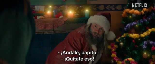 Video Reference: Santa Claus, Christmas tree, holiday decorations, candles, festive, indoors, warm lighting, man, red suit, beard, subtitles, Netflix, winter holiday, decorated room
