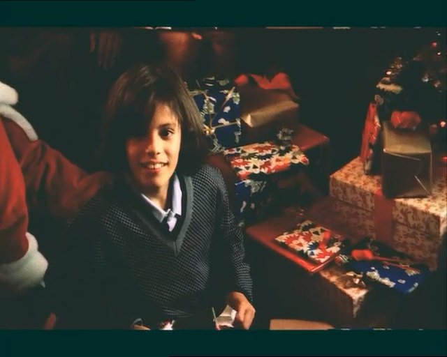 Video Reference: child, wrapped gifts, holiday, indoor, portrait, festive, present boxes, smiling, gifts, home, celebration, seasonal