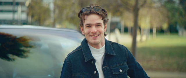 Video Reference: Clothing, Face, Smile, Outerwear, Eye, Facial expression, Plant, Flash photography, Beard, Standing