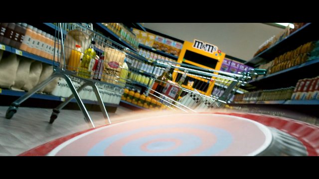 Video Reference: supermarket, shopping cart, grocery aisle, shelves, groceries, store interior, candy display, aisle perspective, retail, food products, indoor, motion blur