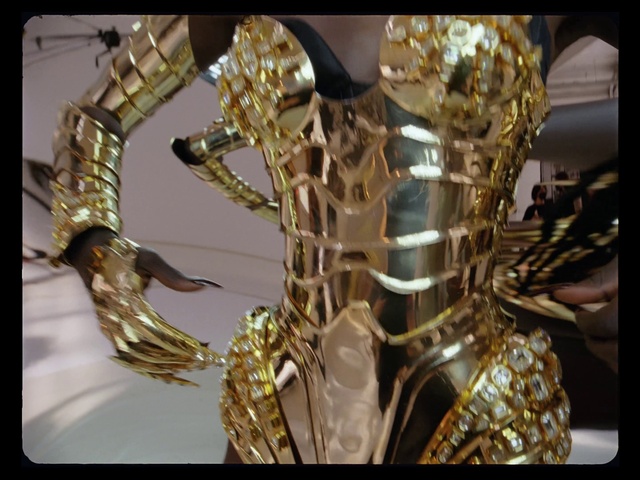 Video Reference: Gold, Jewellery, Glass, Natural material, Body jewelry, Metal, Art, Event, Fashion accessory, Bronze