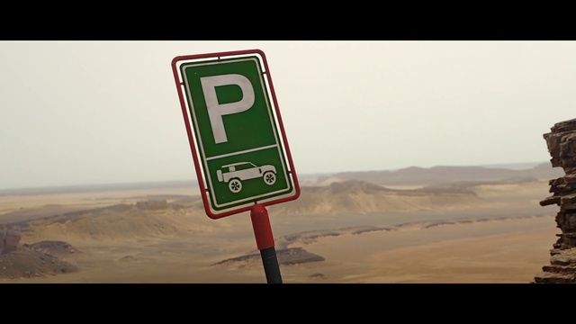 Video Reference: Sky, Font, Slope, Natural landscape, Landscape, Road, Traffic sign, Signage, Aeolian landform, Street sign