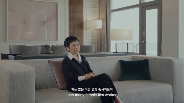 Video Reference: woman, interview, living room, sofa, indoor, modern interior, subtitles, sitting, conversation, home, portrait, furniture, bright, elegant, documentary, talking