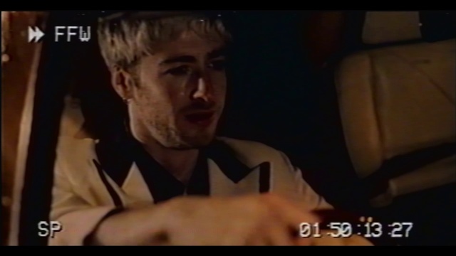 Video Reference: Jaw, Gesture, Flash photography, Beard, Screenshot, Font, Photo caption, Event, Pleased, Facial hair