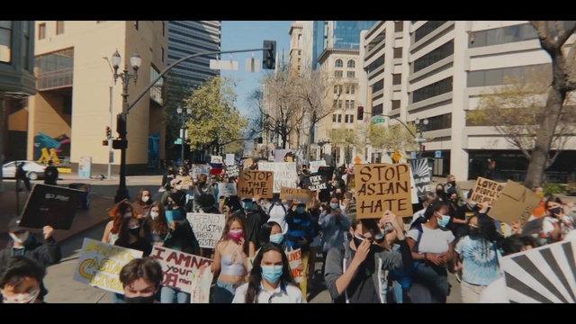 Video Reference: Building, Tree, Public space, Window, Crowd, City, Event, Urban area, Urban design, Font