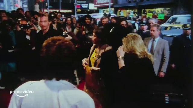 Video Reference: Coat, Crowd, Suit, Hat, Event, Personal luxury car, T-shirt, Flooring, Fun, City