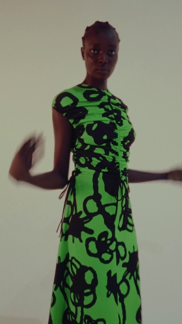 Video Reference: Head, Outerwear, One-piece garment, Shoulder, Dress, Day dress, Neck, Waist, Sleeve, Gesture