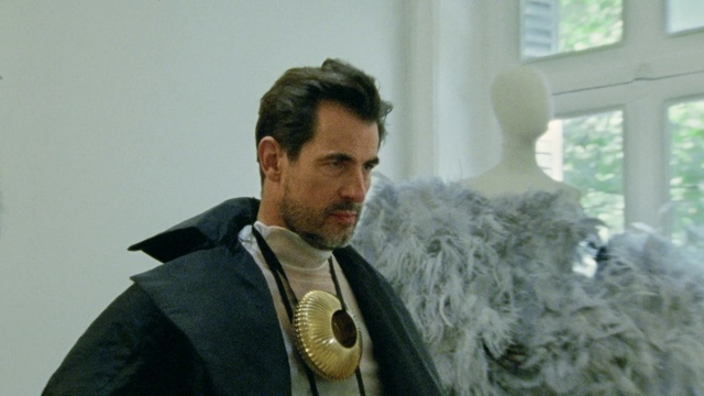 Video Reference: Outerwear, Sleeve, Beard, Collar, Dress shirt, Window, Facial hair, Blazer, Natural material, Fashion design