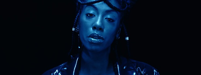 Video Reference: Lip, Eyebrow, Blue, Eyelash, Purple, Flash photography, Jaw, Entertainment, Performing arts, Music artist