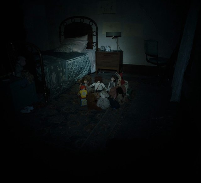 Video Reference: bedroom, bed, nightstand, chair, dolls, stuffed toys, dark, indoor, night, toy collection, furniture, eerie, low light, home interior