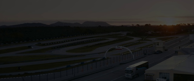 Video Reference: Sky, Vehicle, Truck, Asphalt, Tree, Runway, Road, Landscape, Road surface, Dusk