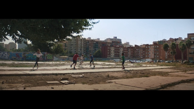 Video Reference: Building, Sky, Road surface, Asphalt, Tree, Urban design, City, Sports equipment, Tints and shades, Leisure
