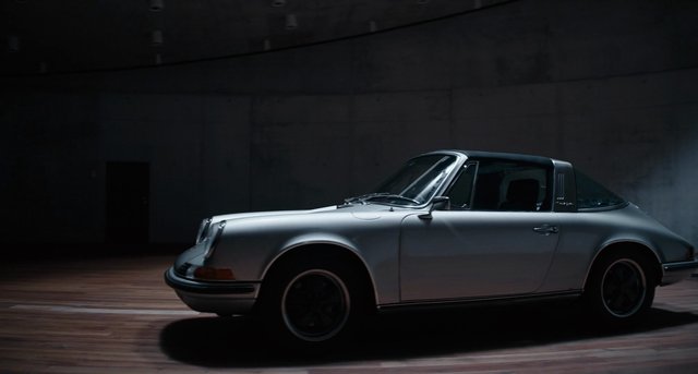 Video Reference: classic car, coupe, silver car, vintage vehicle, indoor, studio lighting, sports car, wooden floor, side view, automobile, dark background, elegant, retro, transportation