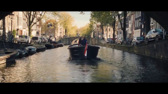Video Reference: Water, Building, Boat, Sky, Vehicle, Tree, Watercraft, Window, Road surface, Car