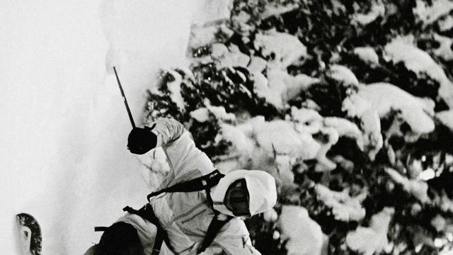 Video Reference: skiing, snowboarder, winter, snow, action, outdoors, mountain, sport, black and white, trees, slope, helmet, jacket, adventure