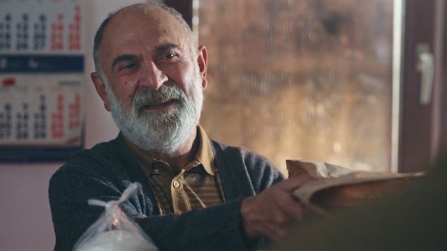 Video Reference: Forehead, Mouth, Beard, Smile, Gesture, Flash photography, Wrinkle, Tableware, Dress shirt, Facial hair