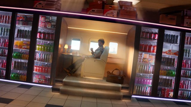 Video Reference: private jet, airplane cabin, man, luxury, interior, beverage shelves, drink, travel, seat, window, cabinet, soft lighting, premium, aircraft, snack display