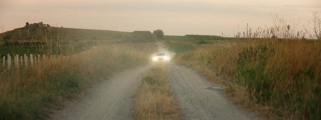 Video Reference: Sky, Car, Plant, Vehicle, Natural landscape, Asphalt, Land lot, Road surface, Plain, Grassland
