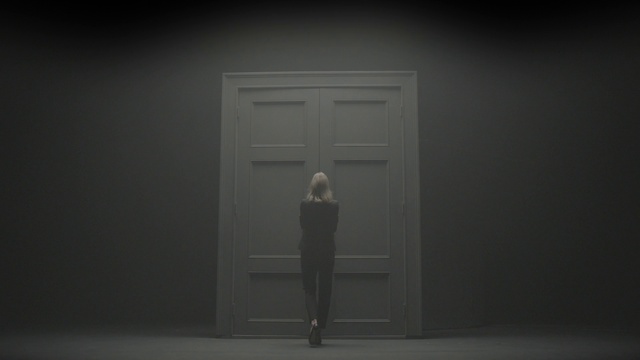 Video Reference: Outerwear, Door, Flash photography, Sleeve, Wood, Building, Grey, Home door, Tints and shades, Flooring