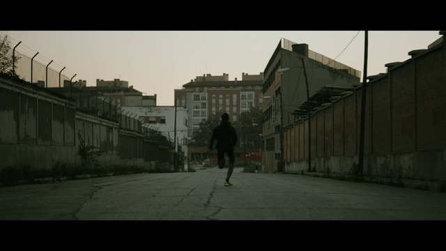 Video Reference: Sky, Building, Road surface, Asphalt, Grey, Neighbourhood, Atmospheric phenomenon, City, Tints and shades, Facade