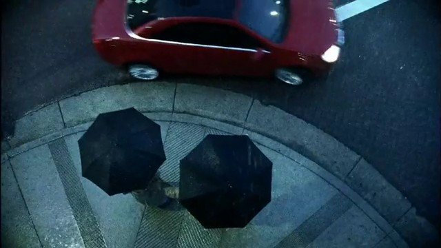 Video Reference: rain, street, car, sidewalk, umbrella, overhead, urban, wet, night, traffic, pedestrians, red car
