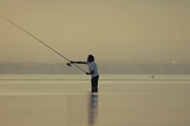 Video Reference: fishing, angler, water, sunset, silhouette, outdoors, rod, lake, sea, standing, reflection, calm, horizon, nature, recreation