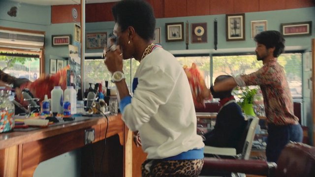Video Reference: barbershop, haircut, hair styling, mirror, barber chair, grooming, interior, people, salon, counter, windows, daylight, tools, bottles, casual clothing