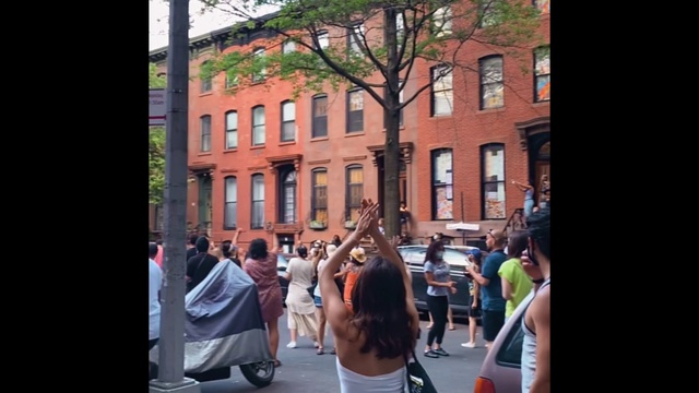 Video Reference: Window, Building, Car, Tree, Neighbourhood, Travel, Street fashion, T-shirt, Leisure, City