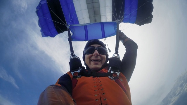 Video Reference: Smile, Outerwear, Sky, Blue, Parachute, Black, Paragliding, Gesture, Cloud, Parachuting