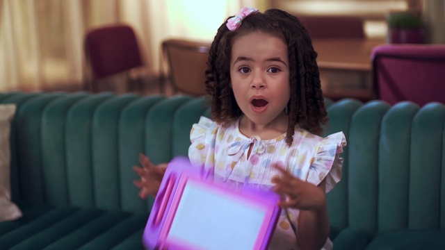 Video Reference: Hair, Facial expression, Purple, Fashion, Happy, Fun, Leisure, Chair, Child, Toddler