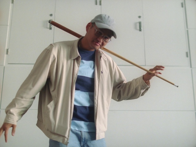 Video Reference: Hat, Sleeve, Gesture, Dress shirt, Cap, Collar, Sun hat, Blazer, Fashion accessory, Wood