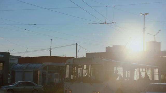 Video Reference: Sky, Atmosphere, Building, Window, Automotive lighting, Electricity, Sunlight, Car, Tire, Overhead power line