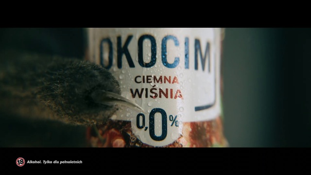 Video Reference: Bird, Font, Automotive lighting, Glass bottle, Electric blue, Automotive exterior, Darkness, Drink, Terrestrial animal, Brand