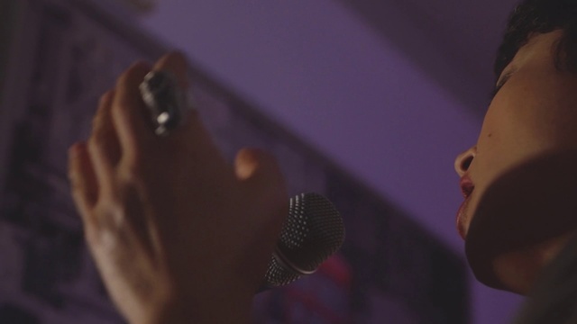 Video Reference: Microphone, Purple, Music artist, Gesture, Musician, Entertainment, Music, Audio equipment, Violet, Performing arts
