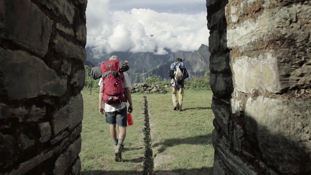 Video Reference: Footwear, Shorts, Cloud, Sky, Mountain, Luggage and bags, Highland, Travel, Outdoor recreation, Terrain