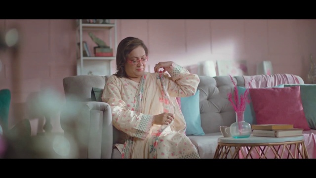 Video Reference: Glasses, Comfort, Flash photography, Dress, Happy, Couch, Magenta, Event, Fashion design, Sitting