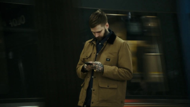 Video Reference: Sleeve, Collar, Audio equipment, Eyewear, Flash photography, Event, Facial hair, Fashion design, Trench coat, Darkness