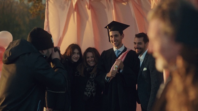 Video Reference: Smile, Outerwear, Scholar, Coat, Academic dress, Mortarboard, Graduation, Fashion, Hat, Gesture