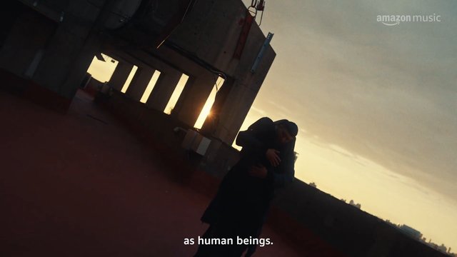 Video Reference: rooftop, sunset, embrace, silhouette, city skyline, industrial, outdoor, evening, dramatic lighting, urban, two people, romantic, tilted angle